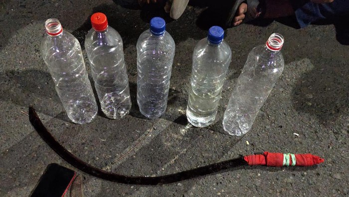 Barang bukti ciu dan celurit yang diamankan polisi usai menggerebek pesta miras di Semarang, Minggu (22/9/2024).