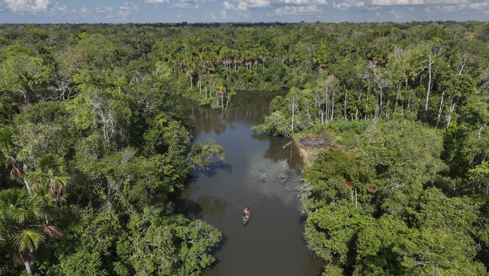 Indigenous ride a boat on the Komi Memem River, named Laje in non-Indigenous maps, at the Wari' Indigenous community in Guajara-Mirim, Rondonia state, Brazil, Thursday, July 13, 2023. The Amazon city of Guajara-Mirim recently approved a law that designates the Laje River 