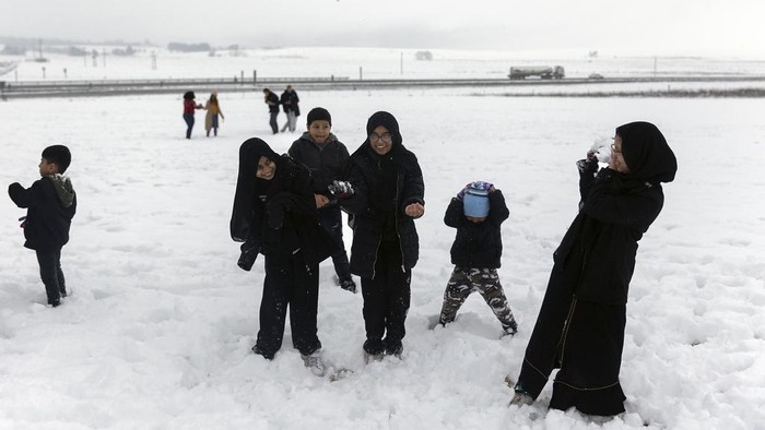 People play in unseasonal snow in Nottingham Road, near Durban, South Africa, Saturday, Sept. 21, 2024. (AP Photo)