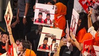 Pendukung Pramono-Rano mengangkat poster kepada cagub-cawagub yang diusung PDIP dan Hanura tersebut.