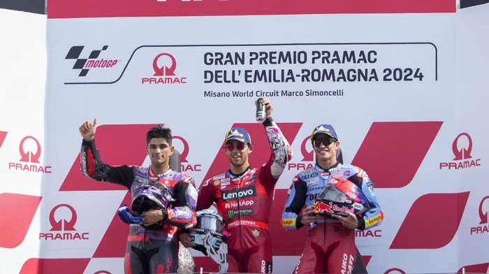 Race winner Italian rider Enea Bastianini of the Ducati Lenovo Team, center, poses on the podium with second placed Spains rider Jorge Martin of the Prima Pramac Racing, left, and third placed Spains rider Marc Marquez of the Gresini Racing MotoGP after the MotoGP race of the Emilia Romagna Motorcycle Grand Prix at the Misano circuit in Misano Adriatico, Italy, Sunday, Sept. 22, 2024. (AP Photo/Gregorio Borgia)