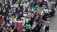 Polisi tampak mengatur arus lalu lintas yang padat.  