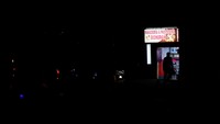 Seorang pria berjalan keluar dari toko roti yang diterangi oleh generator portabel saat listrik padam di Quito, Ekuador, Senin (23/9/2024).  
