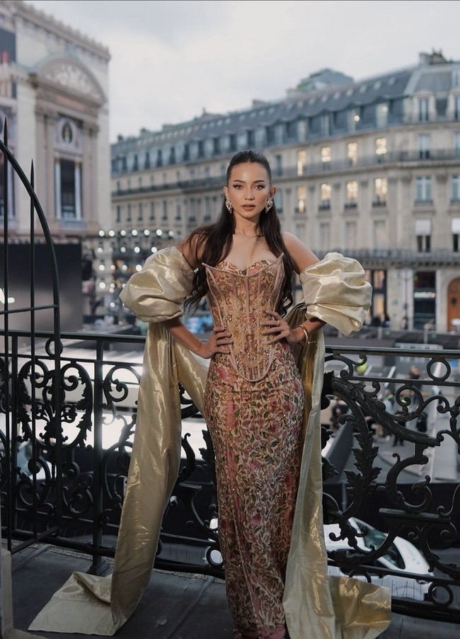 Enzy Storia tampil dalam balutan gaun strapless dengan siluet korset yang dilengkapi selendang krem metalik menambah kesan mewah. Foto: (Instagram/@enzystoria @bubahalfian)