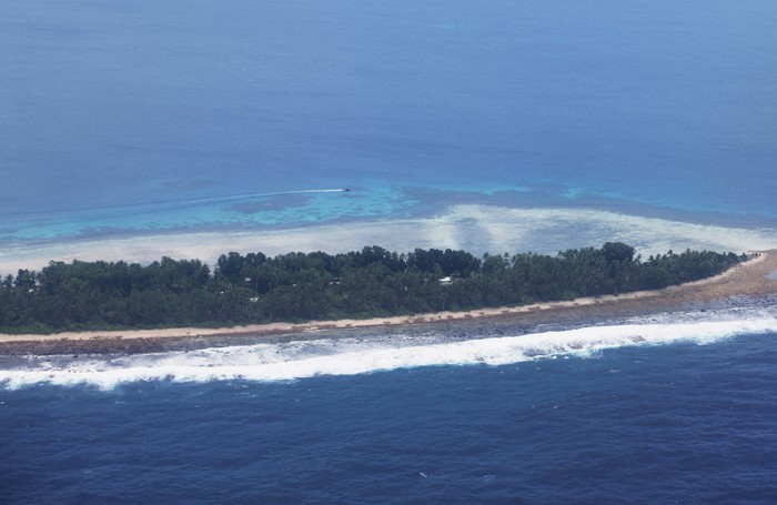 Aerial view of Funafuti, Tuvalu’s most populous island, showing the port and main town of Fongafale, September 6, 2024. Picture taken through plane window. REUTERS/Kirsty Needham