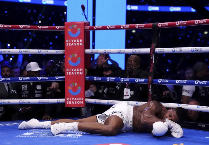 Anthony Joshua lies knocked out in the IBF World Heavyweight bout against Daniel Dubois at Wembley Stadium, in London, Saturday, Sept. 21, 2024. (Bradley Collyer/PA via AP)