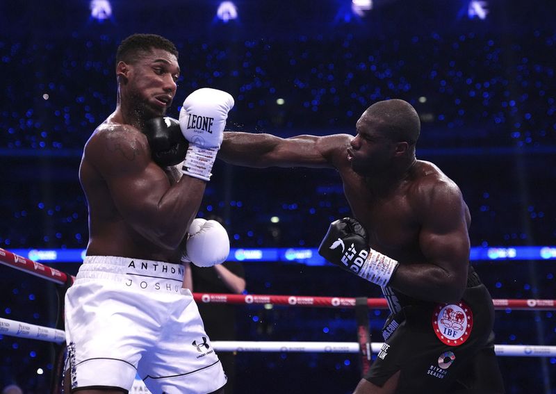 Anthony Joshua lies knocked out in the IBF World Heavyweight bout against Daniel Dubois at Wembley Stadium, in London, Saturday, Sept. 21, 2024. (Bradley Collyer/PA via AP)