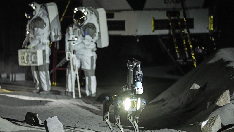 An astronaut cheers with ESA director Josef Aschbacher after a training in lunar surface simulating conditions for future moon missions, like the Artemis lunar exploration program led by NASA, at the opening of the new LUNA facility at the European Astronaut Center, near Cologne, Germany, Wednesday, Sept. 25, 2024. (AP Photo/Martin Meissner)