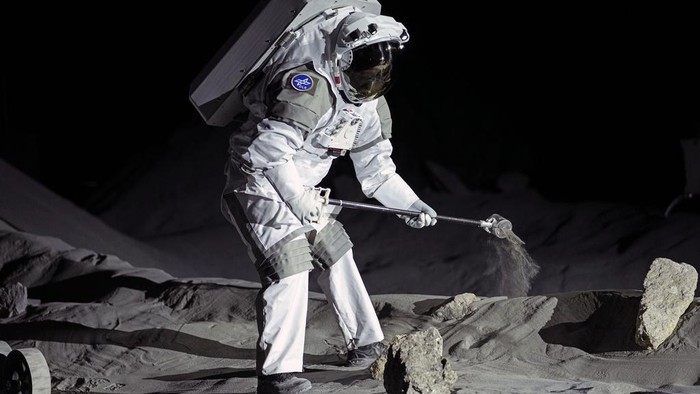 An astronaut cheers with ESA director Josef Aschbacher after a training in lunar surface simulating conditions for future moon missions, like the Artemis lunar exploration program led by NASA, at the opening of the new LUNA facility at the European Astronaut Center, near Cologne, Germany, Wednesday, Sept. 25, 2024. (AP Photo/Martin Meissner)