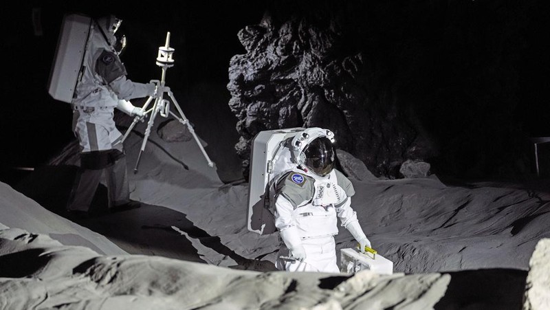 An astronaut cheers with ESA director Josef Aschbacher after a training in lunar surface simulating conditions for future moon missions, like the Artemis lunar exploration program led by NASA, at the opening of the new LUNA facility at the European Astronaut Center, near Cologne, Germany, Wednesday, Sept. 25, 2024. (AP Photo/Martin Meissner)