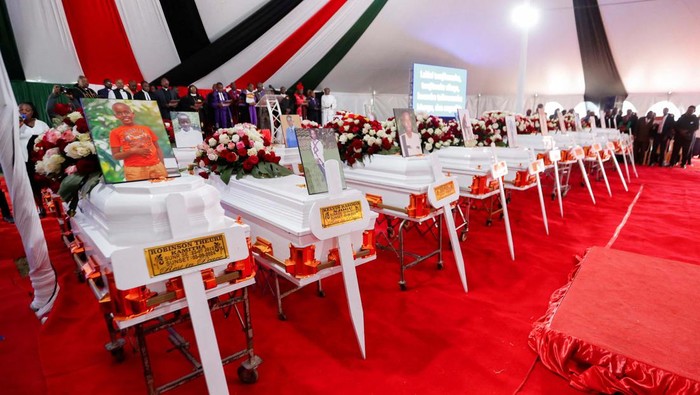 Candles representing the deceased children are lit near the coffins before a memorial service for the pupils who died after a fatal fire at the Hillside Endarasha Academy within Kieni in Nyeri County, Kenya September 26, 2024. REUTERS/Thomas Mukoya