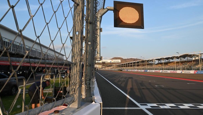 Seorang pria melintasi deretan safety car menjelang balapan MotoGP 2024 Mandalika di Pertamina Mandalika International Street Circuit, Lombok Tengah, NTB, Rabu (25/9/2024). MotoGP Mandalika akan berlangsung pada 27-29 September. ANTARA FOTO/Akbar Nugroho Gumay/nz
