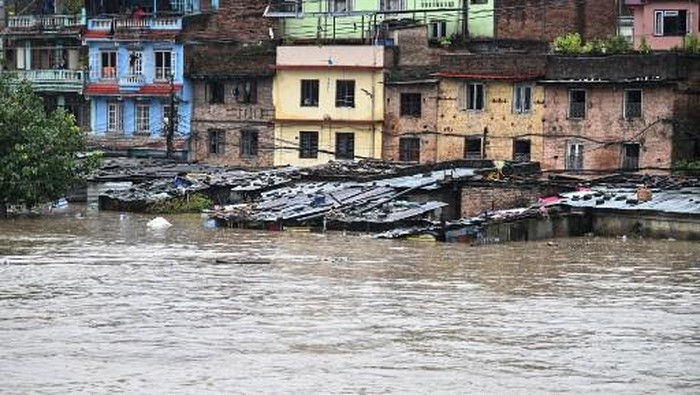 A general view shows houses submerged in flood waters after the Bagmati river overflowed during monsoon rains in Kathmandu on September 28, 2024. Floods and landslides caused by heavy downpours in Nepal killed at least 10 people across the Himalayan country, with rescue teams searching for 18 missing, a disaster official said on September 28. (Photo by PRAKASH MATHEMA / AFP)