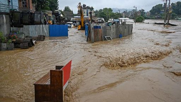 A general view shows houses submerged in flood waters after the Bagmati river overflowed during monsoon rains in Kathmandu on September 28, 2024. Floods and landslides caused by heavy downpours in Nepal killed at least 10 people across the Himalayan country, with rescue teams searching for 18 missing, a disaster official said on September 28. (Photo by PRAKASH MATHEMA / AFP)