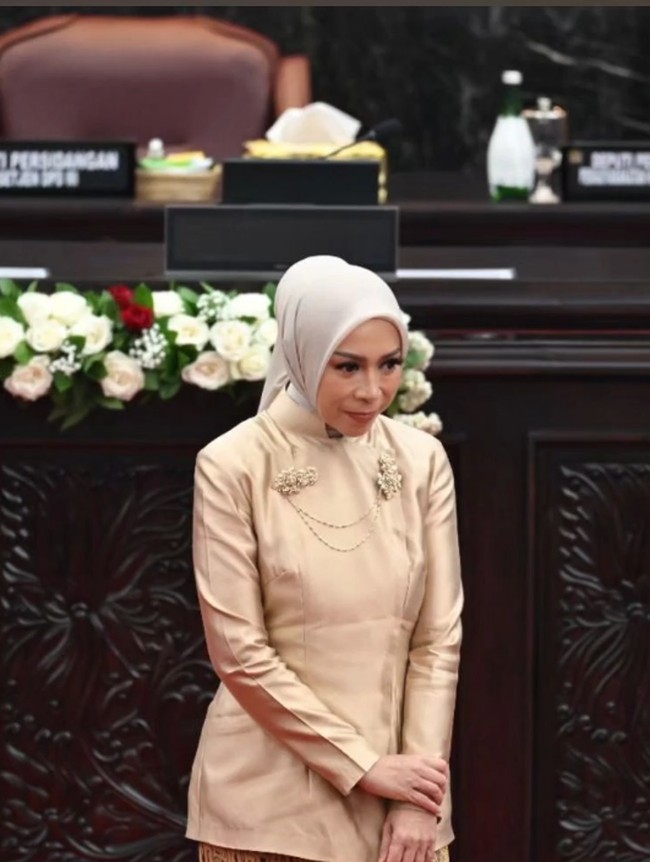 Penyanyi Melly Goeslaw memilih tampil sederhana dalam balutan kebaya janggan warna emas metalik. Wanita berdarah Sunda ini mempercantik kebayanya dengan bros yang disematkan di bagian dada. Jilbabnya juga dibuat minimalis namun bersahaja.  Foto: Instagram