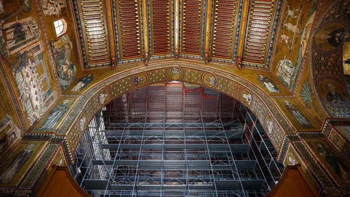 Golden mosaics are seen on the ceiling and behind the scaffolding inside the Monreale Cathedral, a UNESCO World Heritage site that combines Western, Islamic and Byzantine styles, in Monreale, Sicily, Italy, August 25, 2024. REUTERS/Guglielmo Mangiapane