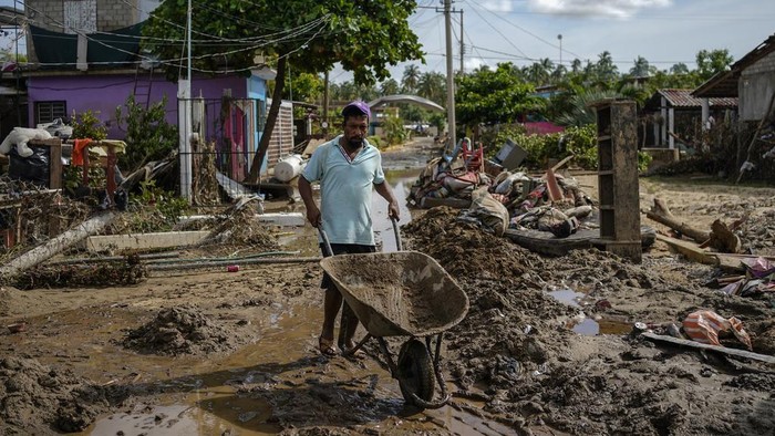 A man burns a dead horse after Hurricane John passed through Coyuca de Benitez, Guerrero state, Mexico, Monday, Sept. 30, 2024. (AP Photo/Felix Marquez)