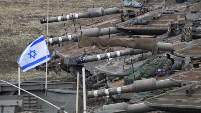 Israeli armored personnel carriers (APC) and tanks maneuver in a staging area in northern Israel near the Israel-Lebanon border, Tuesday, Oct. 1, 2024. (AP Photo/Baz Ratner)