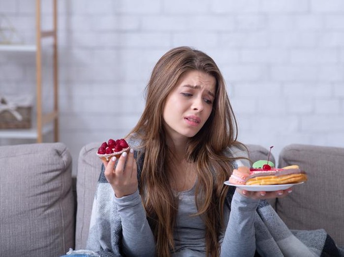 Young Asian woman enjoy eating dessert in cafe on summer vacation trip