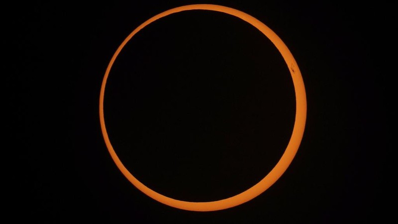 The moon moves across the sun during an annular solar eclipse seen from Tahai, Rapa Nui, or Easter Island, Chile, Wednesday, Oct. 2, 2024. (AP Photo/Esteban Felix)