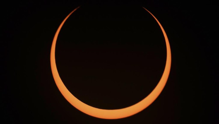 The moon moves across the sun during an annular solar eclipse seen from Tahai, Rapa Nui, or Easter Island, Chile, Wednesday, Oct. 2, 2024. (AP Photo/Esteban Felix)