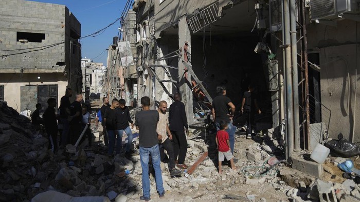 Palestinians examine the damage following an Israeli airstrike in the West Bank city of Tulkarem, which Palestinian health officials say killed 18 people and the Israeli military says took out a Hamas leader, on Friday, Oct. 4, 2024. (AP Photo/Nasser Nasser)
