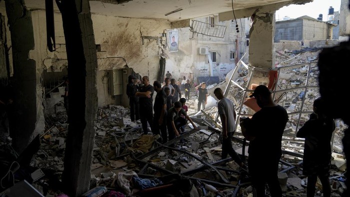 Palestinians examine the damage following an Israeli airstrike in the West Bank city of Tulkarem, which Palestinian health officials say killed 18 people and the Israeli military says took out a Hamas leader, on Friday, Oct. 4, 2024. (AP Photo/Nasser Nasser)