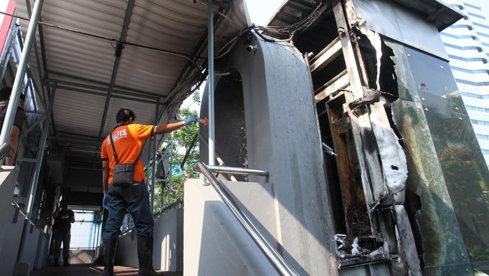 Petugas Dinas Pemadam Kebakaran dan Penyelamatan (DPKP) Kota Surabaya melakukan pembasahan lift jembatan penyeberangan orang (JPO) yang terbakar di Jalan Pemuda, Surabaya, Jawa Timur, Sabtu (5/10/2024). DPKP Kota Surabaya mengerahkan delapan kendaraan pemadam kebakaran untuk memadamkan api yang membakar lift JPO yang diduga disebabkan  korsleting listrik. ANTARA FOTO/Didik Suhartono/nz