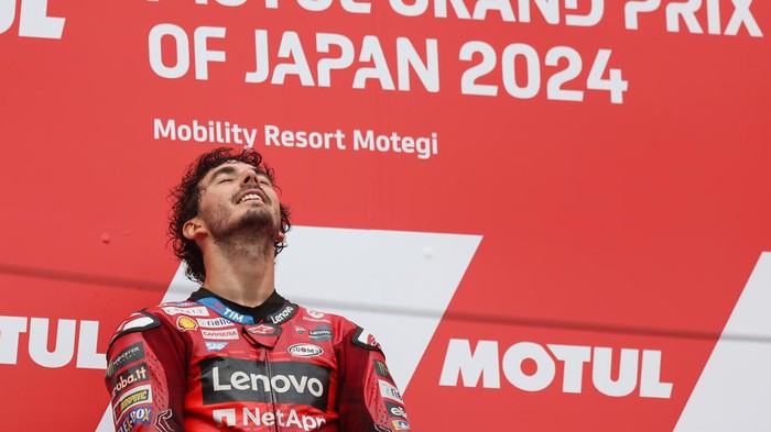 MOTEGI, JAPAN - OCTOBER 06: Race winner Francesco Bagnaia (1) of Italy and Ducati Lenovo Team celebrates on the podium following the MotoGP Japanese Grand Prix at Twin Ring Motegi on October 06, 2024 in Motegi, Japan. (Photo by Mike Owen/Getty Images)