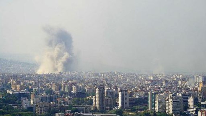 Smoke rises from the site of an Israeli airstrike that targeted a neighbourhood in Beiruts southern suburb on October 6 , 2024. (Photo by ETIENNE TORBEY / AFP)