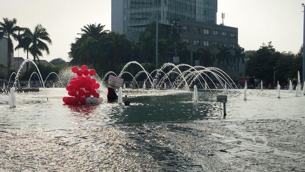 Bawa Balon Merah Putih-Spanduk, Pria Ini Ceburkan Diri ke Kolam Bundaran HI