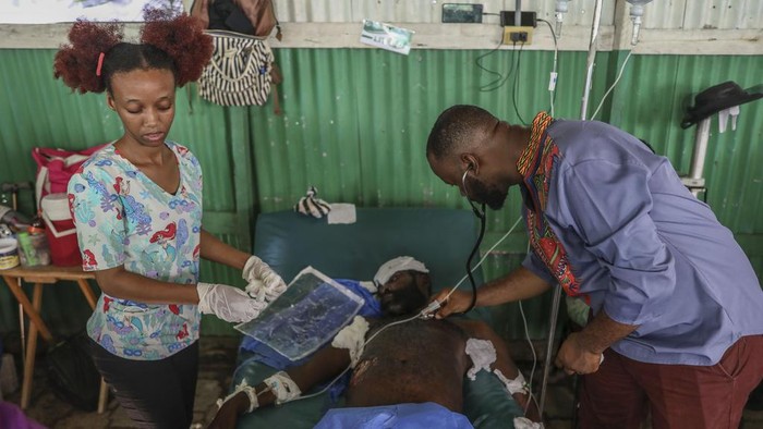 Exiles Junior, wounded by a bullet during armed gang attacks, sits up on a bed at Saint Nicolas hospital in Saint-Marc, Haiti, Sunday, Oct. 6, 2024. (AP Photo/Odelyn Joseph)