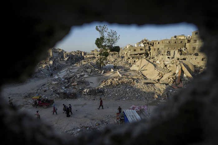 Palestinians mourn relatives killed in the Israeli bombardment of the Gaza Strip, at a hospital in Deir al-Balah, Tuesday, Oct. 1, 2024. (AP Photo/Abdel Kareem Hana)
