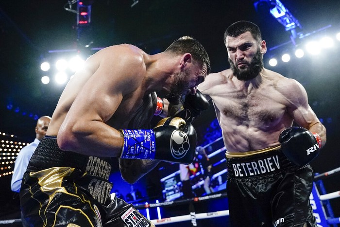 Artur Beterbiev, right, punches Joe Smith Jr. during the second round of a light heavyweight boxing bout Saturday, June 18, 2022, in New York. Beterbiev won in the second round. (AP Photo/Frank Franklin II)