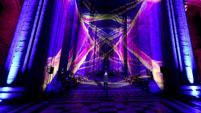 A person watches an art installation Space by Luxmuralis at Durham Cathedral in Durham, Britain, October 8, 2024. REUTERS/Lee Smith