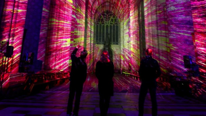 A person watches an art installation Space by Luxmuralis at Durham Cathedral in Durham, Britain, October 8, 2024. REUTERS/Lee Smith
