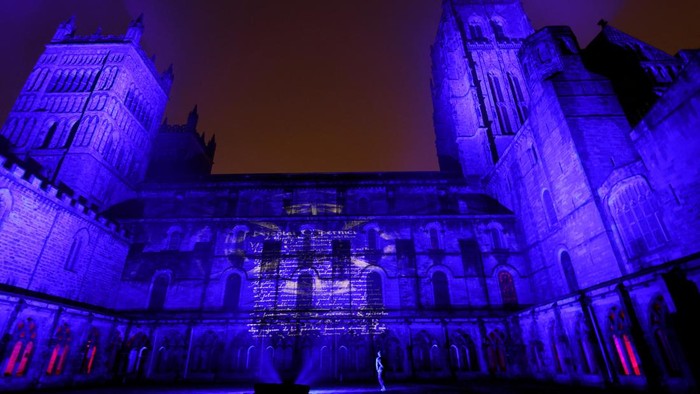 A person watches an art installation Space by Luxmuralis at Durham Cathedral in Durham, Britain, October 8, 2024. REUTERS/Lee Smith