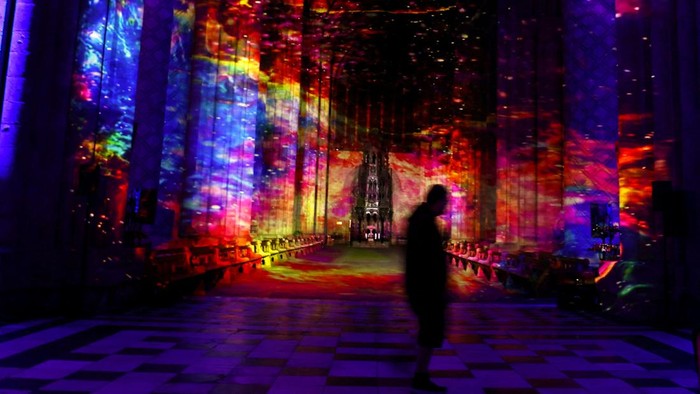 A person watches an art installation Space by Luxmuralis at Durham Cathedral in Durham, Britain, October 8, 2024. REUTERS/Lee Smith