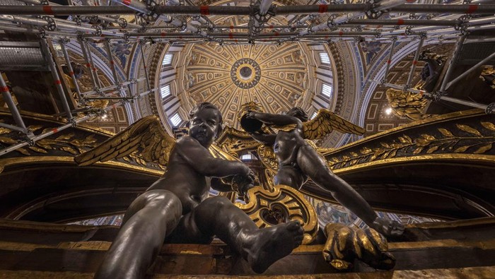 Scaffoldings envelope Bernini's monumental bronze canopy, Tuesday, Oct. 8, 2024, which is situated beneath Michelangelo's massive dome, whose twisting Solomonic columns' gleaming bronze has been concealed for nine months while expert conservators worked meticulously on its intricate surface. (AP Photo/Domenico Stinellis)