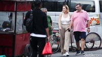Beberapa pejalan kaki berjalan di pinggir jalan ketimbang di trotoar.   