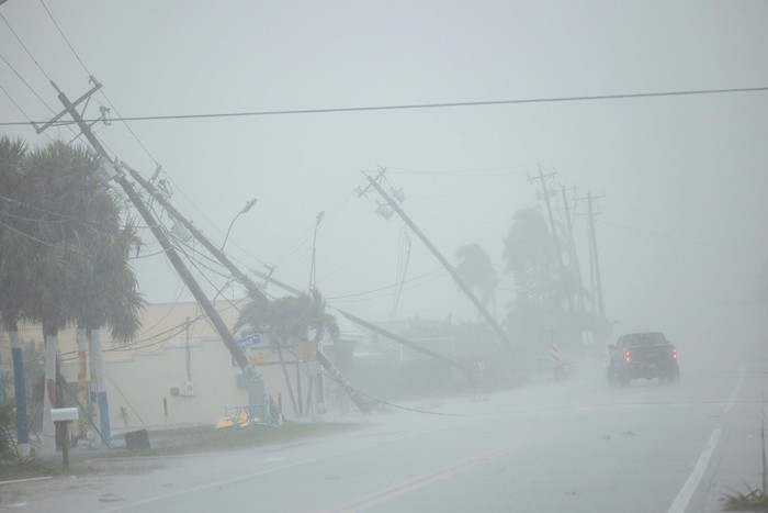Parts of the roof of a gas station lie around palm trees after a passing tornado affected the area as Hurricane Milton approaches Fort Myers, Florida, U.S. October 9, 2024. REUTERS/Ricardo Arduengo