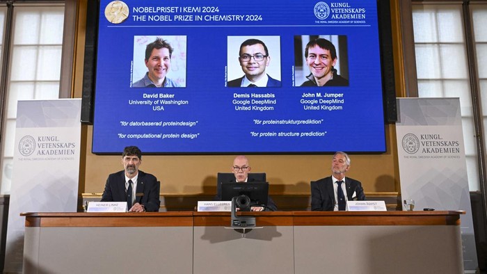 (Bottom L-R) Chair of the Nobel Prize Committee for Chemistry Heiner Linke, Secretary General of the Royal Swedish Academy of Sciences Hans Ellegren and Member of the Nobel Prize Committee for Chemistry Johan Aqvist announce the laureates of the 2024 Nobel Prize in Chemistry, (On screen L-R)  David Baker, Demis Hassabis and John M Jumper, at the Royal Swedish Academy of Sciences in Stockholm, Sweden on October 9, 2024. The Royal Swedish Academy of Sciences has decided to award the 2024 NobelPrize in Chemistry with one half to David Baker ìfor computational protein designî and the other half jointly to Demis Hassabis and John M. Jumper ìfor protein structure prediction.î (Photo by Jonathan NACKSTRAND / AFP)