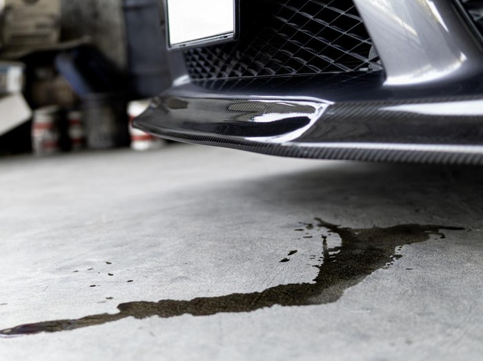 Engine oil stains of car Leak under the car when the car is park on the road  service photo concept for check and maintenance