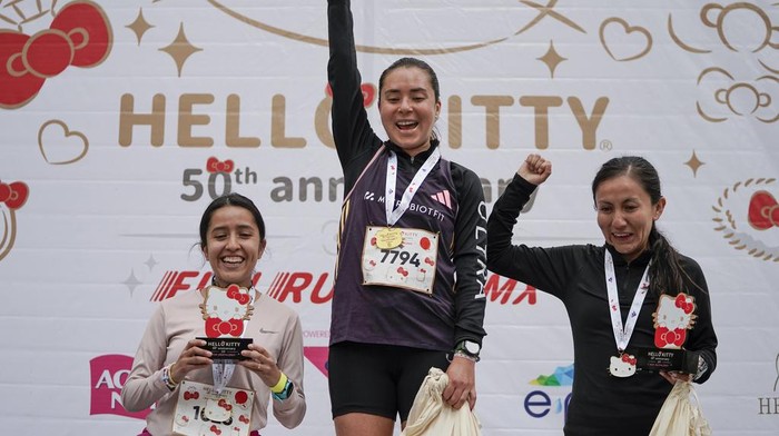 Fans of Japanese character Hello Kitty get ready for a race, during a celebration of the character's 50th anniversary, in Mexico City, Sunday, Oct. 13, 2024. (AP Photo/Aurea Del Rosario)