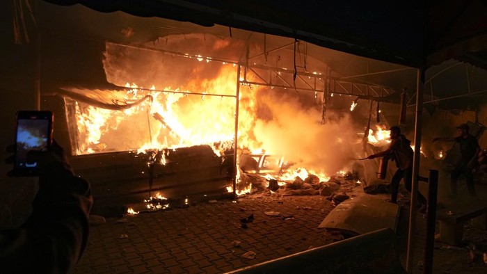 Palestinians react to a fire after an Israeli strike hit a tent area in the courtyard of Al Aqsa Martyrs hospital in Deir al Balah, Gaza Strip, Monday, Oct. 14, 2024. (AP Photo/Abdel Kareem Hana)