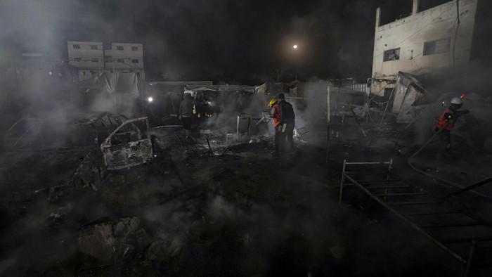 Palestinians react to a fire after an Israeli strike hit a tent area in the courtyard of Al Aqsa Martyrs hospital in Deir al Balah, Gaza Strip, Monday, Oct. 14, 2024. (AP Photo/Abdel Kareem Hana)