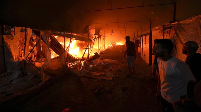 Palestinians react to a fire after an Israeli strike hit a tent area in the courtyard of Al Aqsa Martyrs hospital in Deir al Balah, Gaza Strip, Monday, Oct. 14, 2024. (AP Photo/Abdel Kareem Hana)