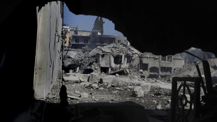 Destroyed shops and buildings at commercial street that hit Saturday night by Israeli airstrikes, in Nabatiyeh town, south Lebanon, Sunday, Oct. 13, 2024. (AP Photo/Mohammed Zaatari)