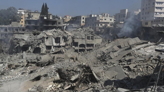 Destroyed shops and buildings at commercial street that hit Saturday night by Israeli airstrikes, in Nabatiyeh town, south Lebanon, Sunday, Oct. 13, 2024. (AP Photo/Mohammed Zaatari)