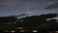 A satellite leaves a trail of light across the tail of the comet C/2023 A3 (Tsuchinshan-ATLAS), with an 80,000 year orbit, known as the comet of the century, after sunset in Ronda, Spain, October 13, 2024. REUTERS/Jon Nazca